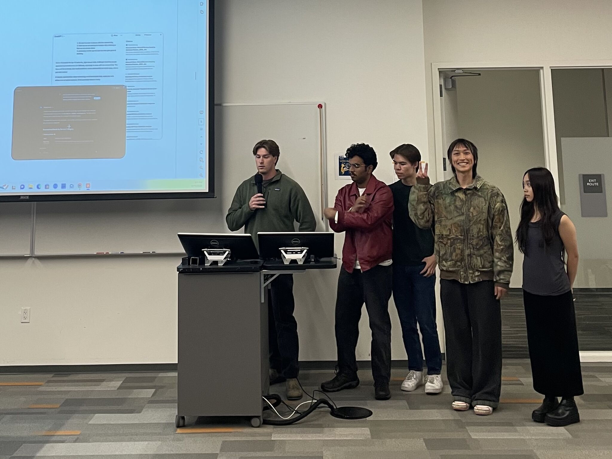 Kaiwen presenting with a group in a classroom.