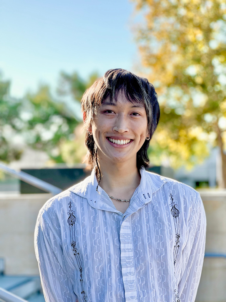 Portrait of Kaiwen Tang smiling outdoors.
